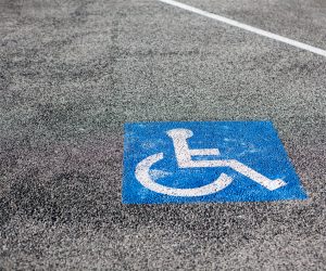 Handicapped parking spot, blue square on asphalt in Cannes Marina, France. Copy space